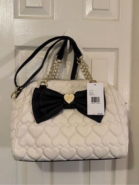 A Betsy Johnson White Quilted Heart Satchel with Black Bow